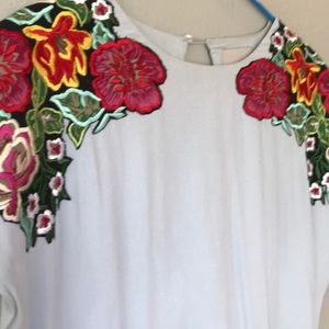 Pale blue dress with embroidered flowers.